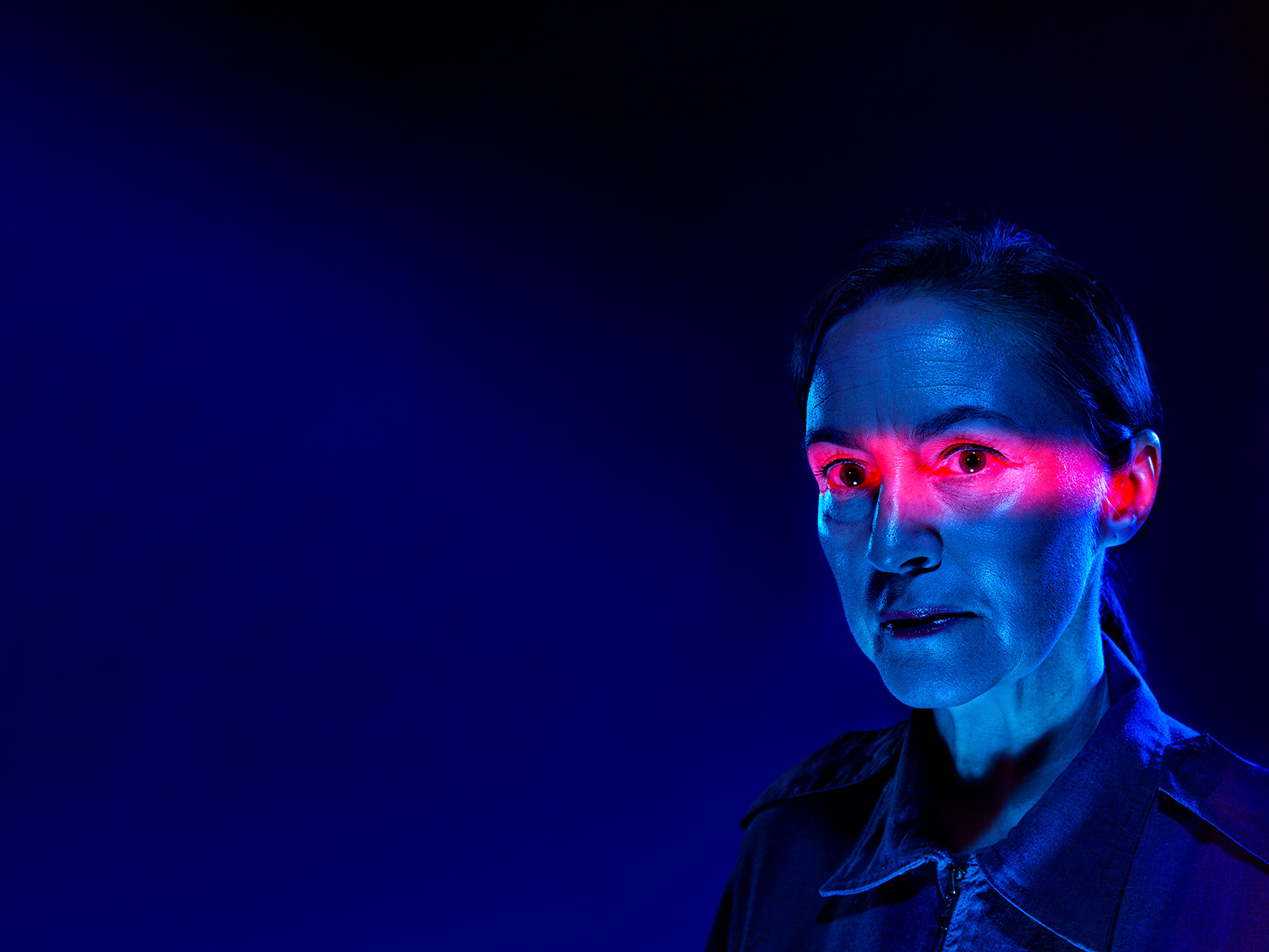 a woman with red light on her eyes