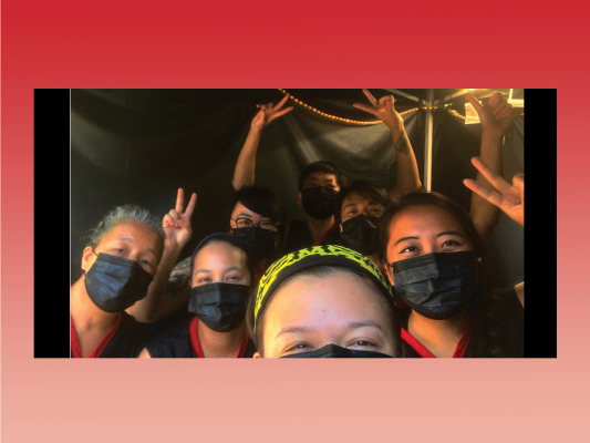 group selfie picture with seven female performers displaying the peace sign