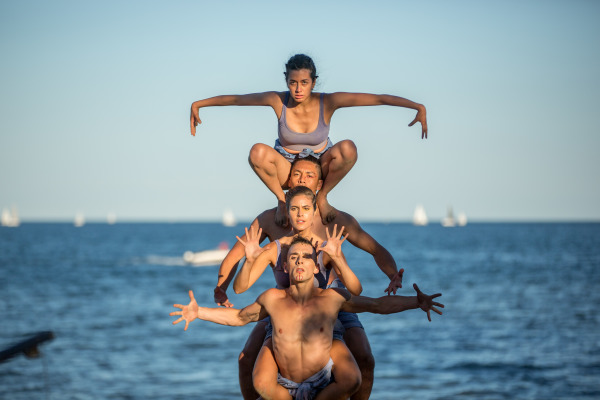 Four dancers positioned on top of each other