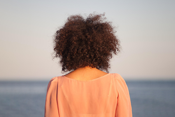 Cloudless image - back of woman staring off into the distance