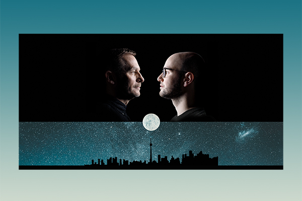 two male faces looking at a silouette of the Toronto sky line