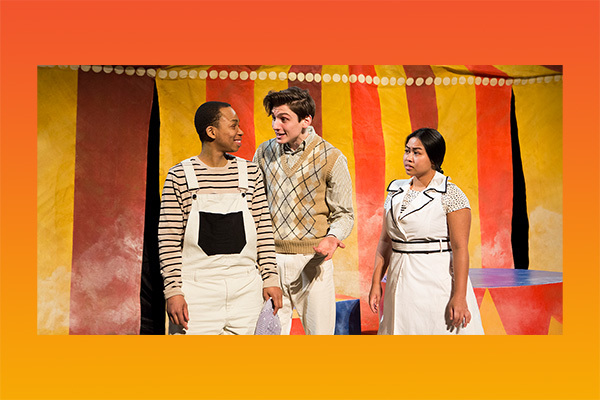 three people in front of a circus tent