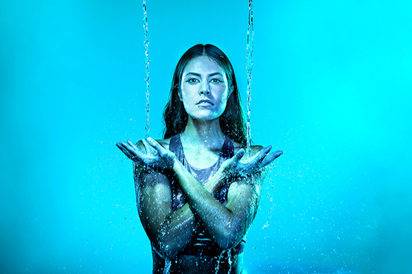 a woman with water falling on her