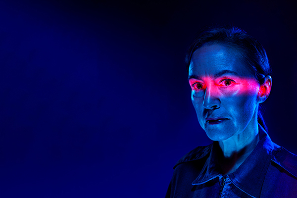 a woman with red light over her eyes